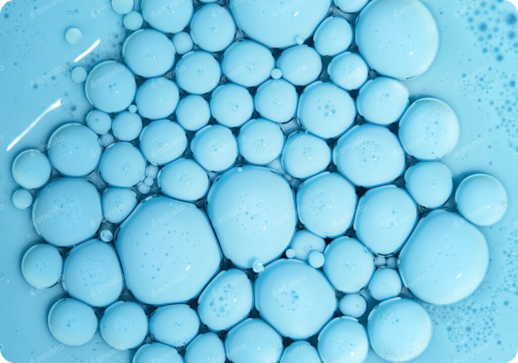 close-up view of light blue droplets in a liquid
